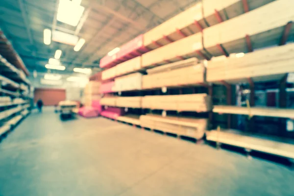Filtered image blurry background lumber stacks on shelves at American hardware store — Stock Photo, Image