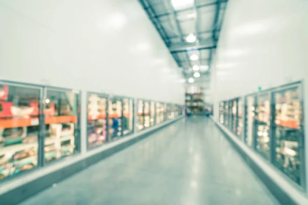 Filtered image blurry background glass door frozen food aisle at big-box store in USA — Stock Photo, Image