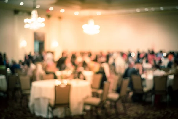 Blurry background diverse people at gala dinner in hotel banquet room