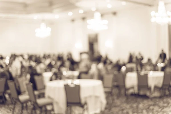 Filtered tone blurry background diverse people at gala dinner in hotel banquet room