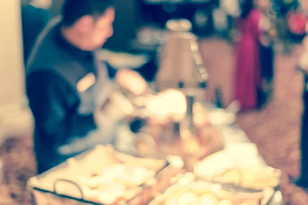 Filtered image blurry background waiter serving food in line at hotel banquet catering — Stock Photo, Image