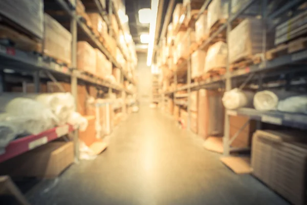 Blurry background variety of mattress and bedding on shelves at furniture warehouse