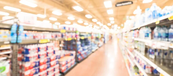 Panoramic view blurry background variety of canned foods on shelf at American supermarket — Stock Photo, Image
