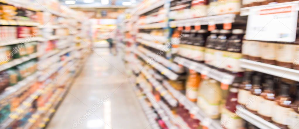 Panoramic view blurry background variety of juices sugar and sport drinks at grocery store in USA