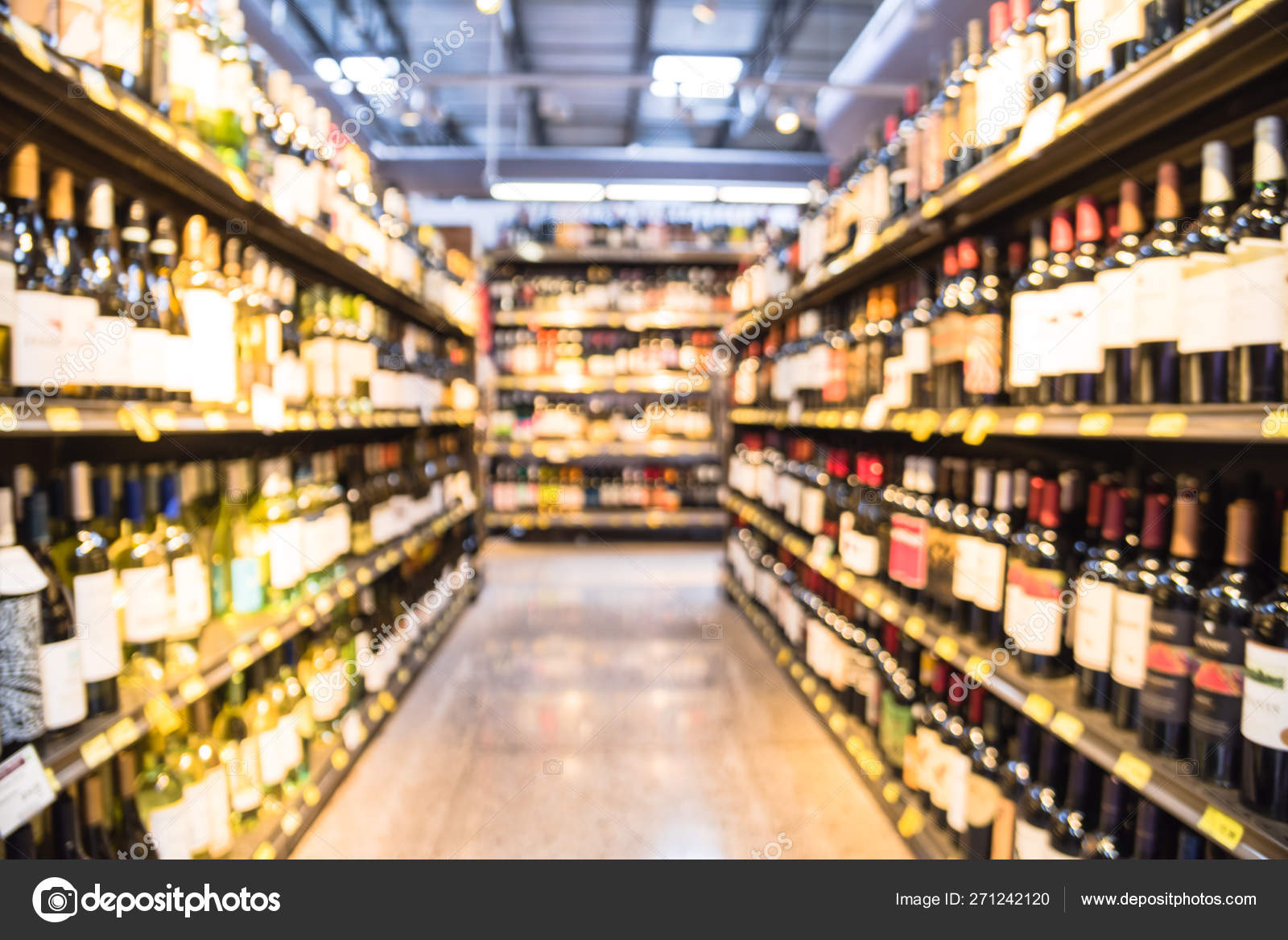 Blurry background variety of wine bottles with price tags at