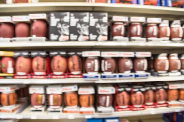 Blurry background full-size American football at sporting goods store clipart