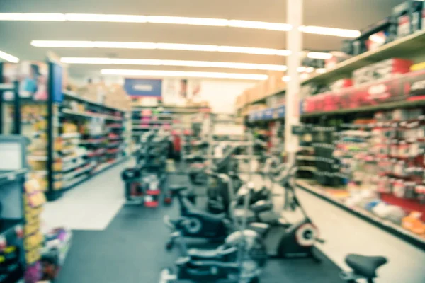 Filtered tone blurry background selection of fitness equipment at sporting goods retail company — Stock Photo, Image