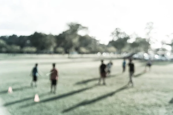Filtered image blurry background Latin America boys playing soccer at park during sunset