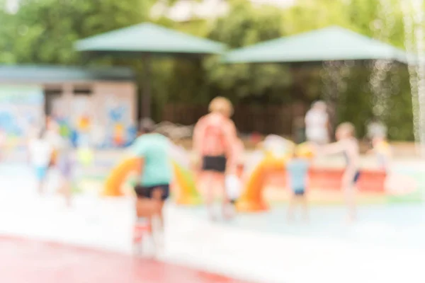 Fondo borroso diversos niños jugando en la almohadilla de salpicadura de agua en Houston, Texas —  Fotos de Stock