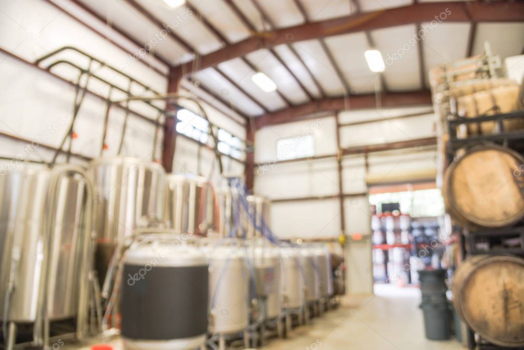 Blurry background fermentation system of beer plant brewing in Texas, USA