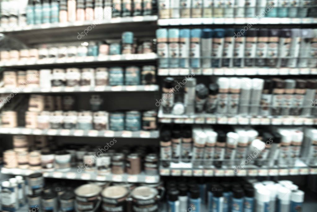 Filtered tone blurry background variety of paint supplies at American grocery store