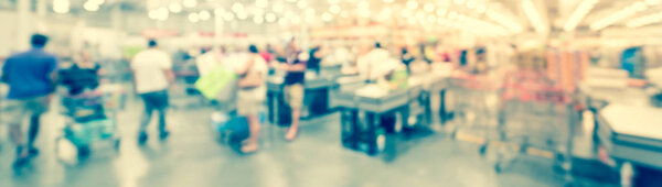 Panoramic view blurry background busy checkout line at wholesale big-box store in America