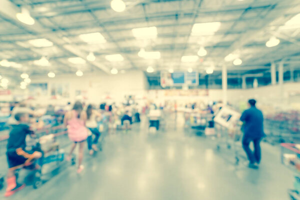 Filtered image blurry background busy checkout line at wholesale big-box store in America