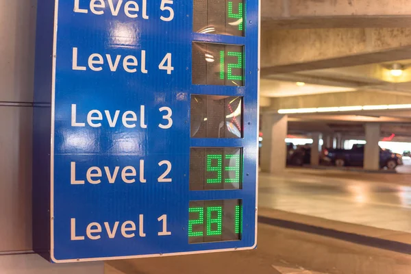 Smart signboard with available spots for each level at parking garage in American airport — Stock Photo, Image