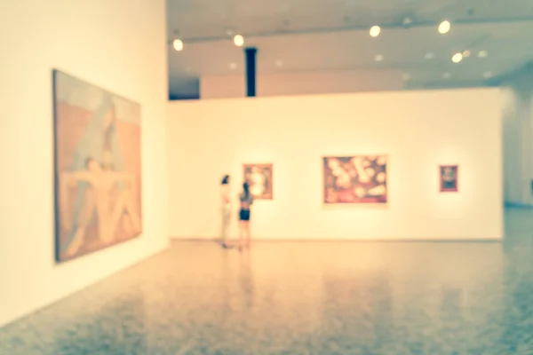 Gente de fondo borrosa mirando exhibición de bellas artes en el museo en América — Foto de Stock