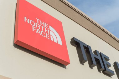 Close-up logo of The North Face at facade entrance of outlet store clipart