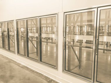 Vintage tone row of empty commercial fridges at wholesale big-box store clipart
