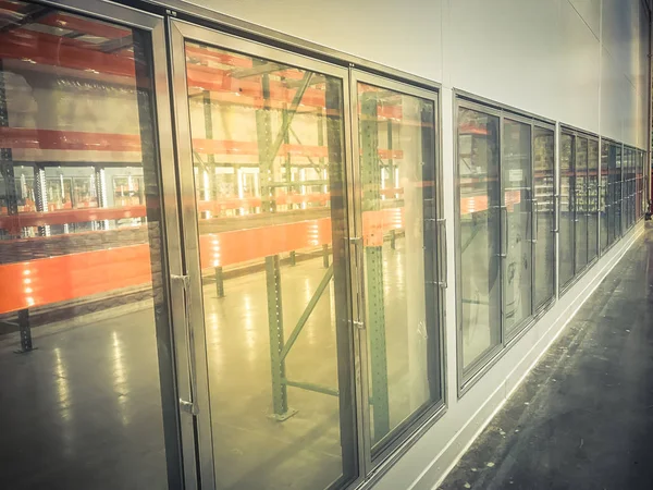 Row of empty commercial fridges at wholesale big-box store