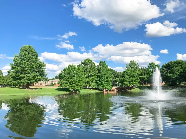 Pond with cloud reflection and water fountain in small American neighborhood — Stock Photo, Image