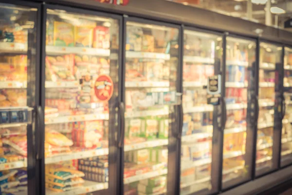Elmosódott háttér különböző fagyasztott és feldolgozott élelmiszerek fagyasztóban az amerikai szupermarketben — Stock Fotó