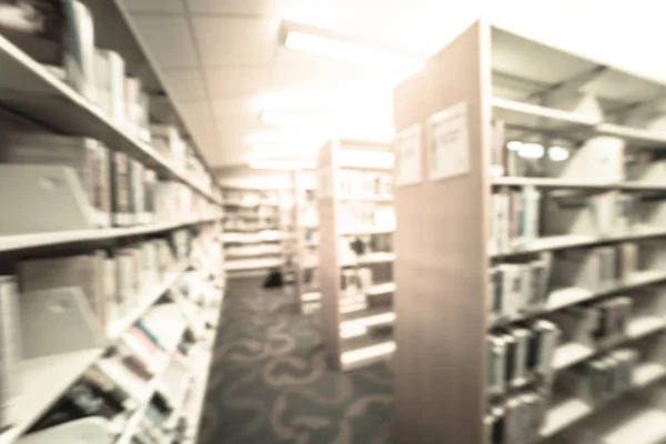 Filtered image blurry background aisle of bookshelf with step stool at public library in USA — Stock Photo, Image