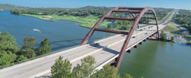 Panoramic Pennybacker Bridge over Colorado river and Hill Country landscape in Austin clipart
