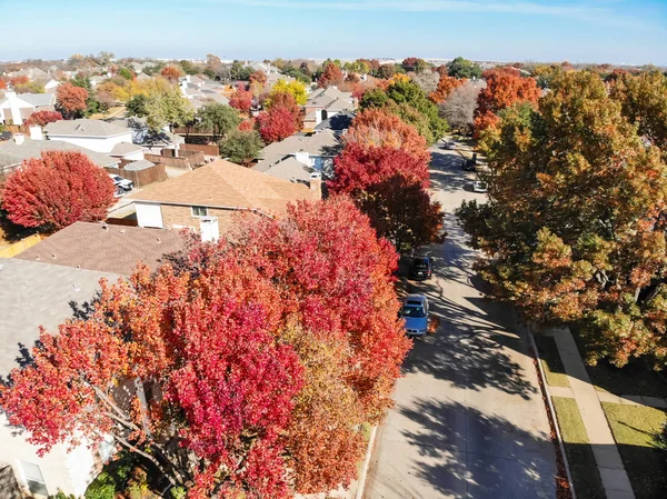 Aerial close-up colorful houses during fall season in residential area near Dallas