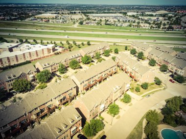 Karayolu ve alışveriş caddeleri yakınında yüzme havuzu ile havadan görünüm apartman