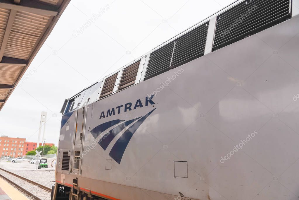 Close-up logo of Amtrak near car train door