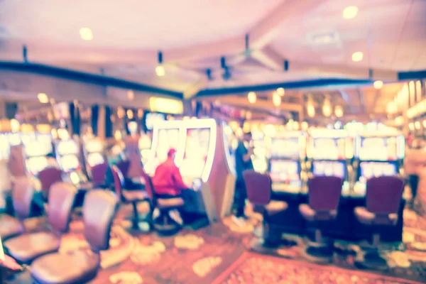 Filtered tone blurry background typical casino in America with slot machines and themed game