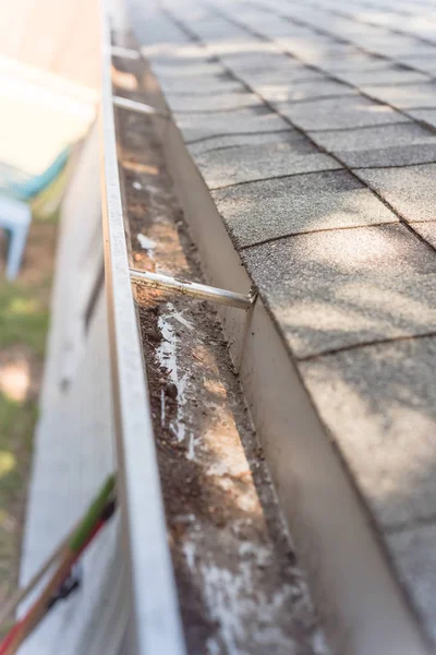 Top view clear gutter after cleaning from leaves and dirt