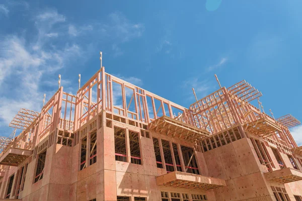 Upward view of multistory apartment building with patio under construction near Dallas, Texas