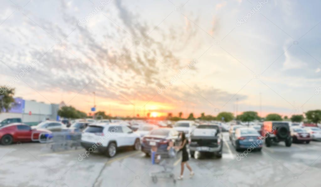 Blurry background customer walking at parking garage with dramatic sunset cloud near Dallas
