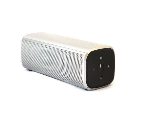Grey bluetooth speaker with rechargeable batteries isolated on white background. Wireless speaker for digital music listening.
