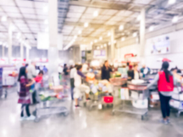 Filtered image blurry background long diverse people queuing at wholesale store checkout counter