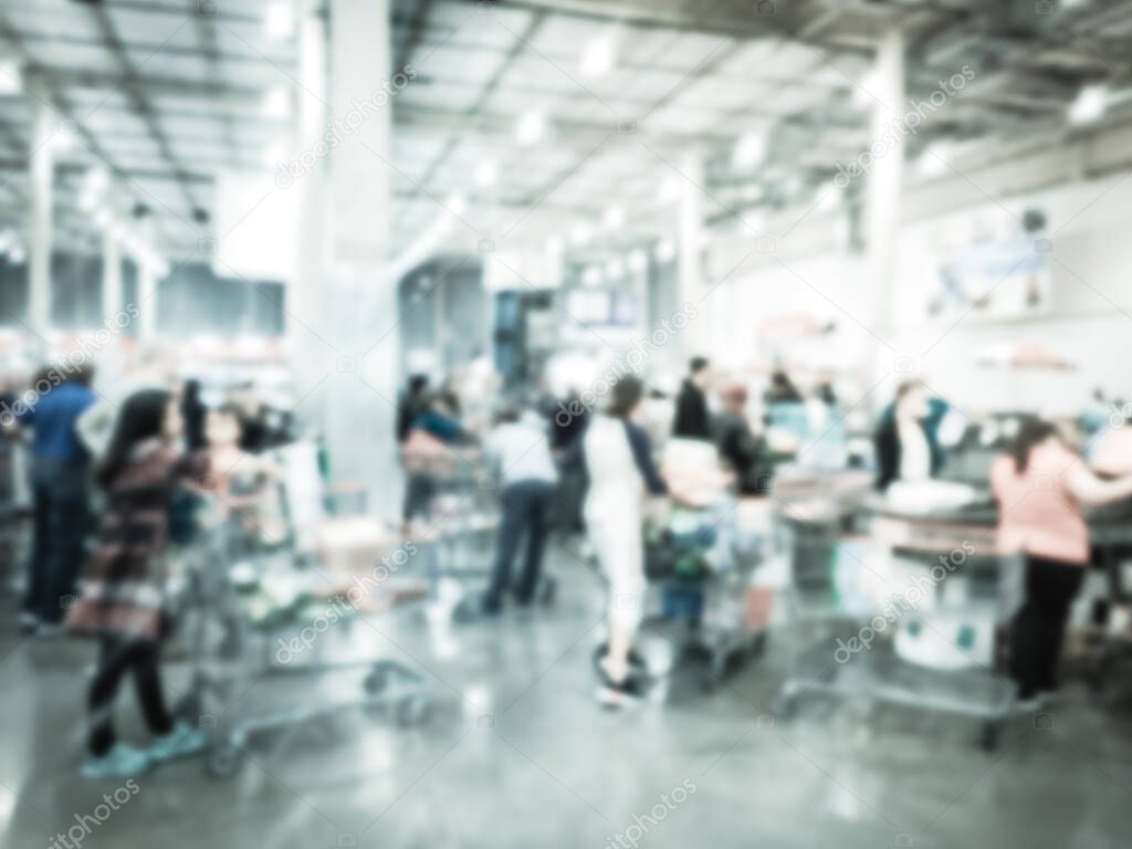 Filtered image blurry background long diverse people queuing at wholesale store checkout counter