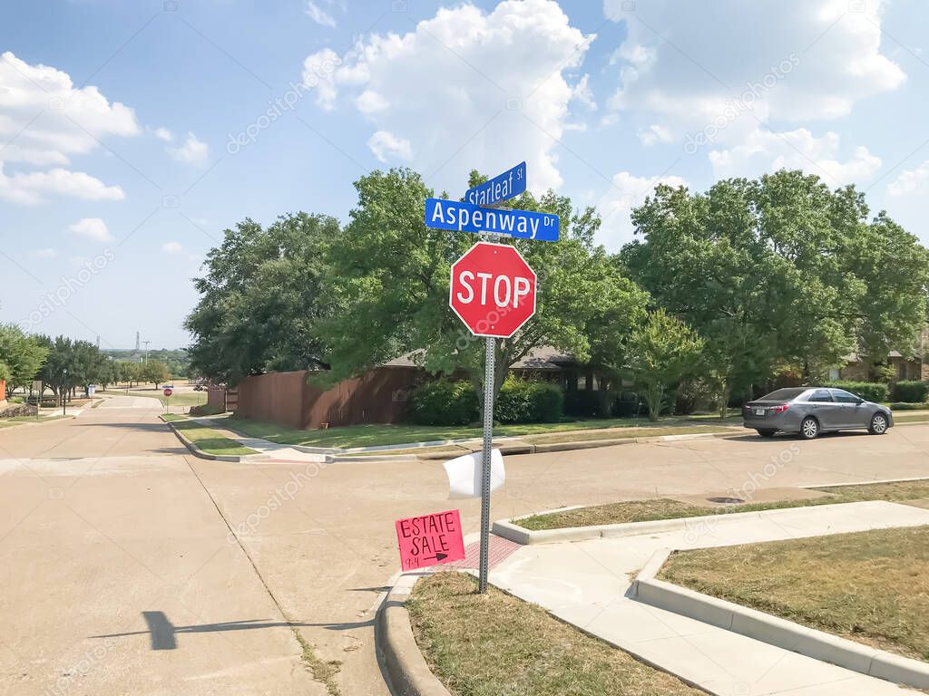 Estate sale sign near all way stop road intersection near Dallas