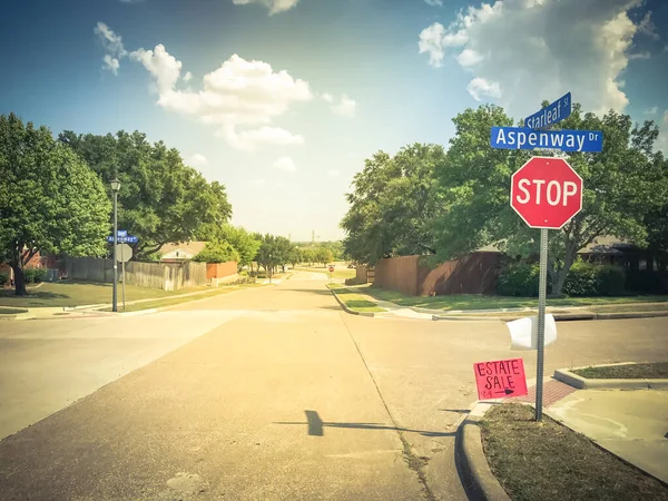 Estate sale sign near all way stop road intersection near Dallas