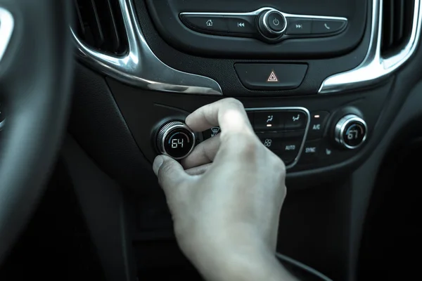 Filtered tone Asian left male hand turning knob button temperature adjust air conditioner to 64 F degree — Stock Photo, Image