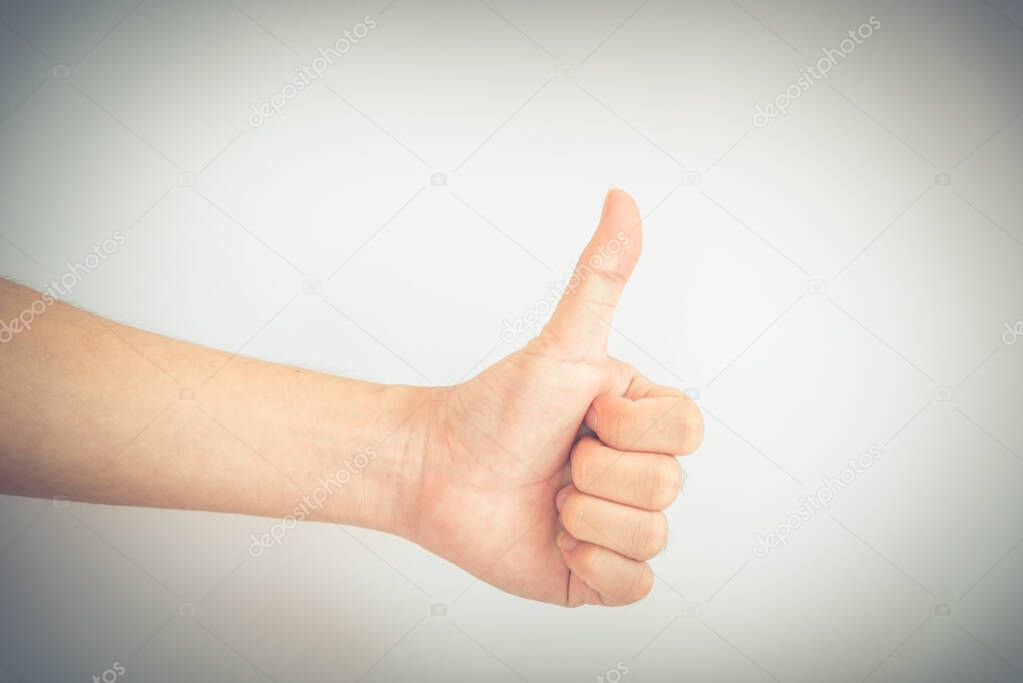 Filtered image studio shot full arm Asian man hand with thumbs up isolated on white
