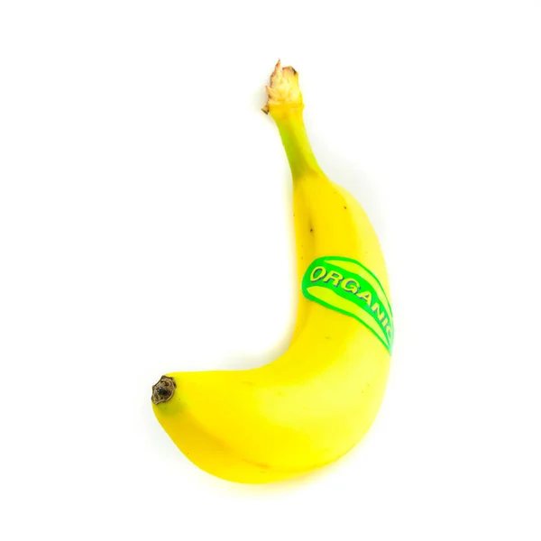 Studio shot organic labeled single whole banana isolated on white — Stock Photo, Image