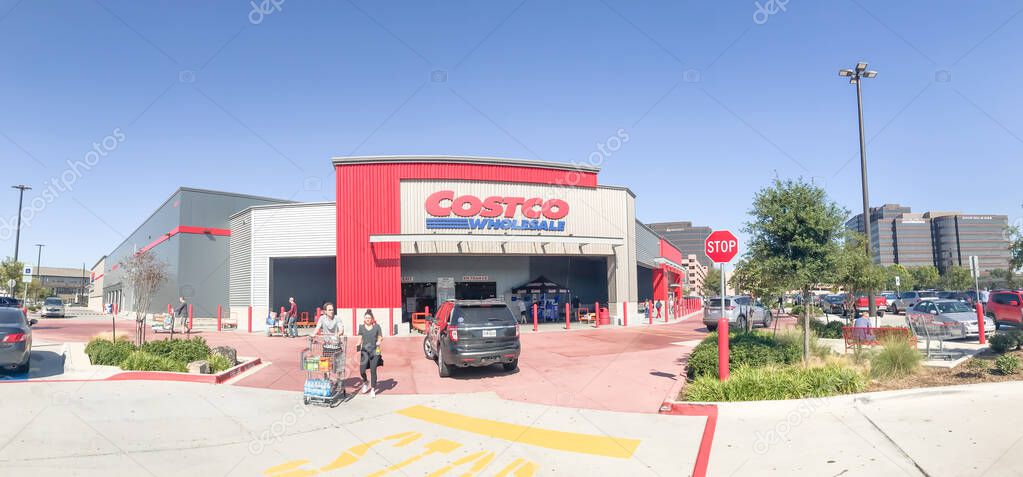 DALLAS, TX, US-OCT 19, 2019: Panorama entrance of Cosco warehouse store in Churchill Way, Dallas. Customers with huge shopping carts enter and exit the building with cars driving by, clear blue sky