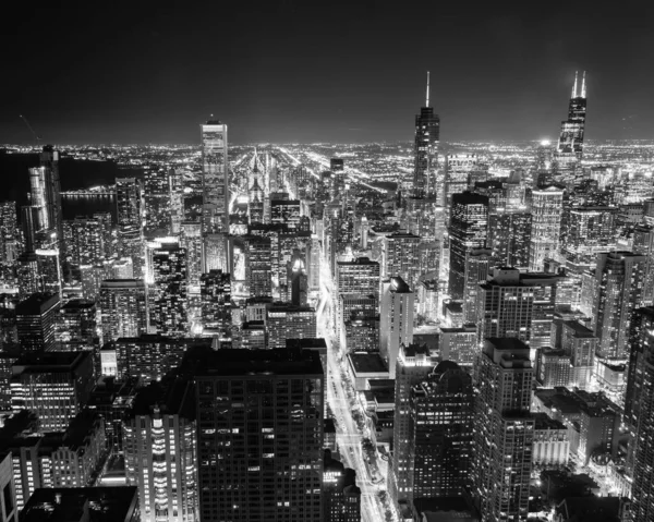 Filtered black and white image aerial view illuminated skyscrapers in downtown Chicago at dusk — Stock Photo, Image