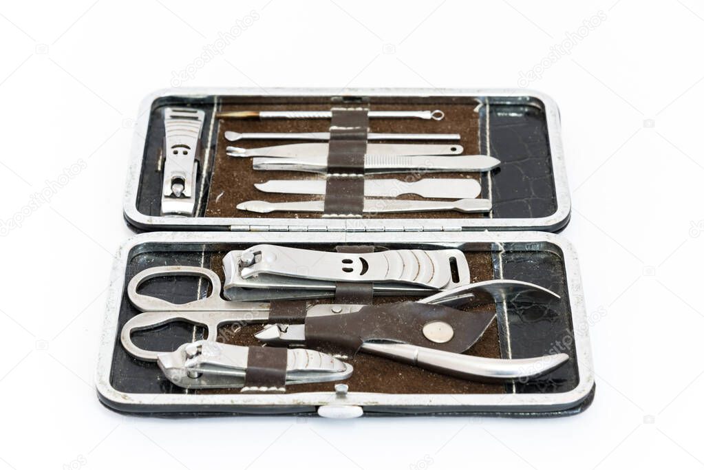 Studio shot grooming kit and nail tools in travel case isolated on white