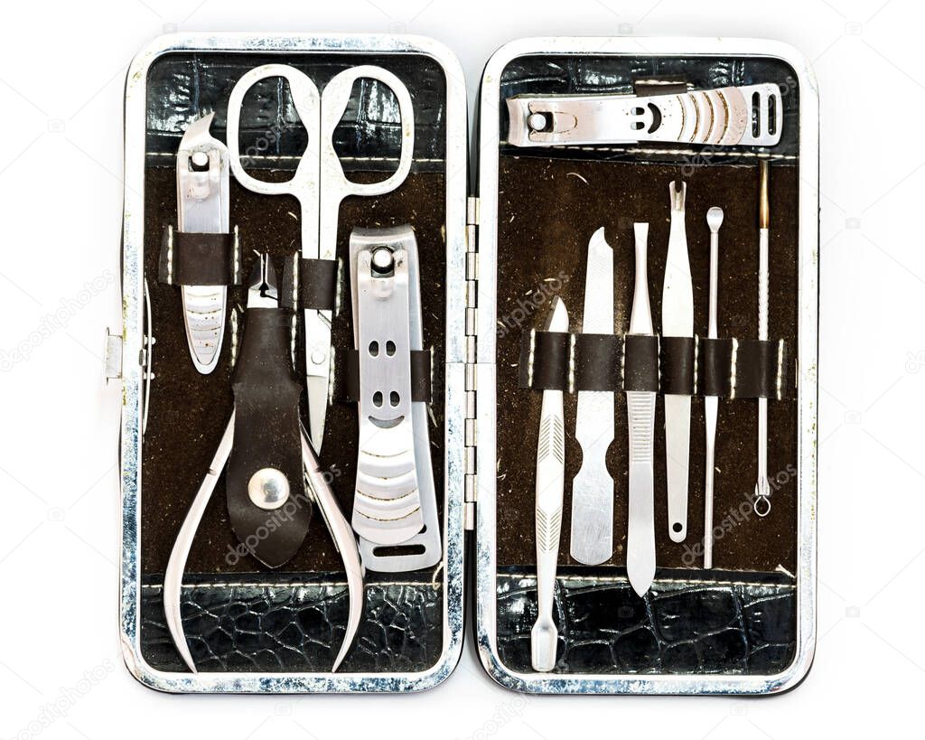 Studio shot top view grooming kit and nail tools in travel case isolated on white