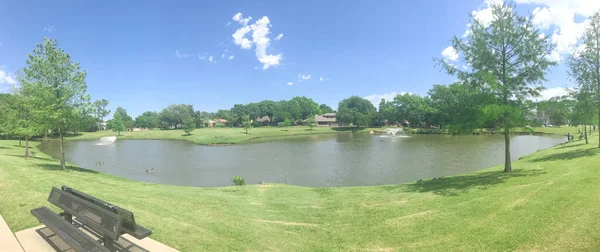 Vue panoramique parc résidentiel avec double voie de fontaines flottantes et banc de pique-nique à Coppell, Texas, États-Unis — Photo