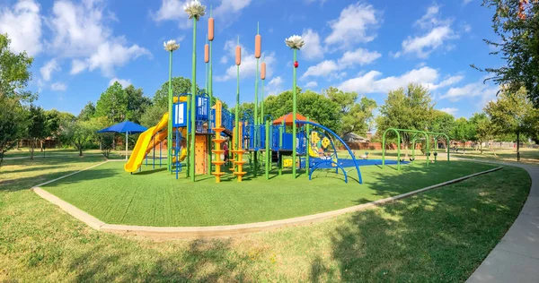 Panoramic view neighborhood playground with sun shade sails, artificial grass in Flower Mound, Texas, America — Stock Photo, Image