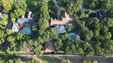 Spacious backyard of luxury homes in Lantana, Texas, swimming pools, and dense tree coverage. Highlights outdoor recreation, privacy, and affluent suburban lifestyle in suburbs Dallas Fort Worth