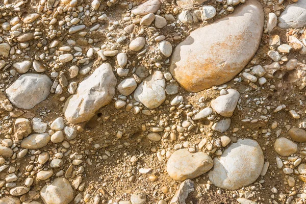 cross section of soil, sand and rock boulders