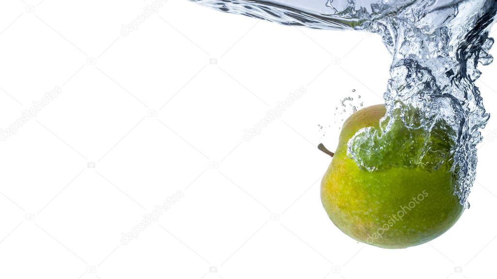 Fresh green apple falling in water on white background close up